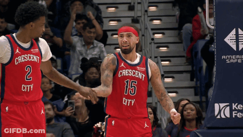 A Basketball Player Wearing A Red Jersey That Says Crescent City Shakes Hands With Another Player GIF