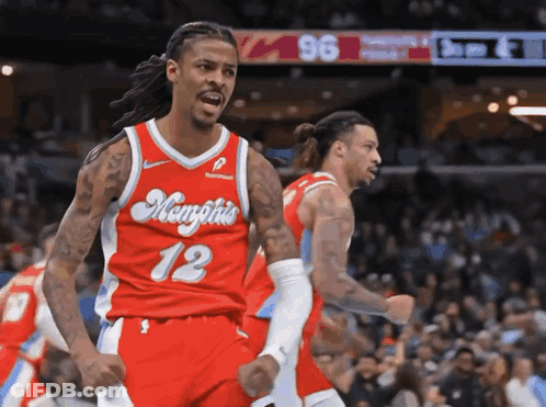A Basketball Player Wearing A Red Jersey With Memphis 12 On It GIF
