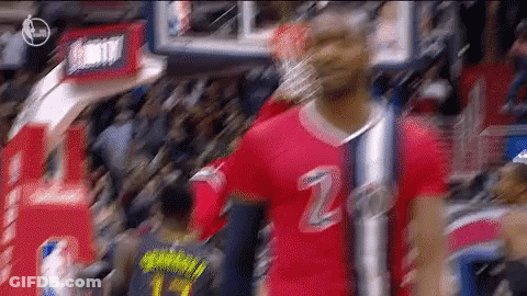 A Basketball Player Wearing A Red Jersey With The Number 2 On It Stands In Front Of A Crowd . GIF