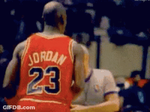 A Basketball Player Wearing A Red Jersey With The Number 23 On The Back GIF