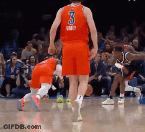 A Basketball Player Wearing A Red Jersey With The Number 3 On It Is Standing On A Court . GIF