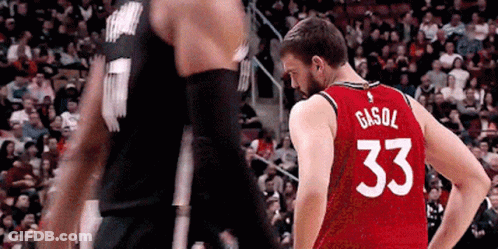 A Basketball Player Wearing A Red Jersey With The Number 33 On The Back Is Standing Next To Another Player . GIF