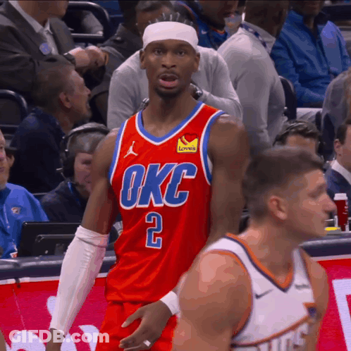 A Basketball Player Wearing A Red Okc Jersey Stands On The Court GIF