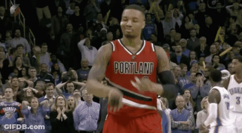 A Basketball Player Wearing A Red Portland Jersey Is Dancing In Front Of A Crowd GIF