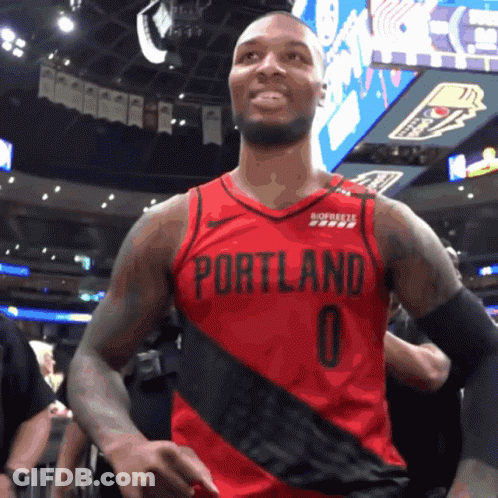 A Basketball Player Wearing A Red Portland Jersey With The Number 0 On It GIF