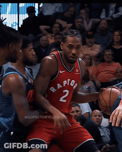 A Basketball Player Wearing A Red Raptors Jersey Is Dribbling The Ball GIF
