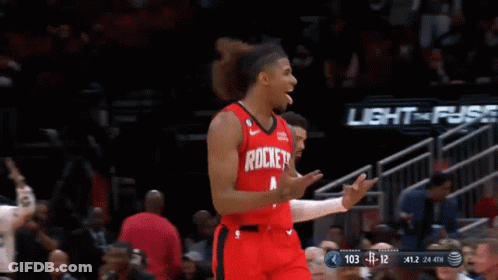 A Basketball Player Wearing A Red Rockets Jersey Celebrates GIF