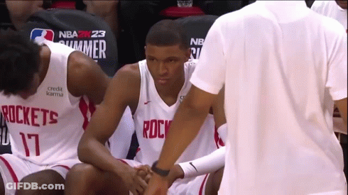A Basketball Player Wearing A Rockets Jersey Talks To Another Player GIF