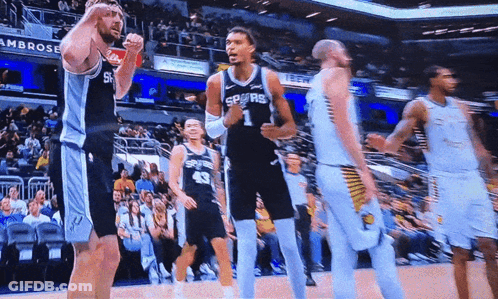 A Basketball Player Wearing A Spurs Jersey Celebrates GIF