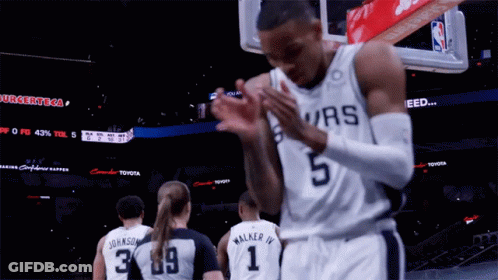 A Basketball Player Wearing A Spurs Jersey Is Clapping GIF