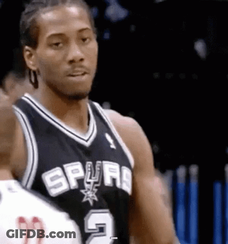 A Basketball Player Wearing A Spurs Jersey Is Standing Next To Another Player On The Court . GIF
