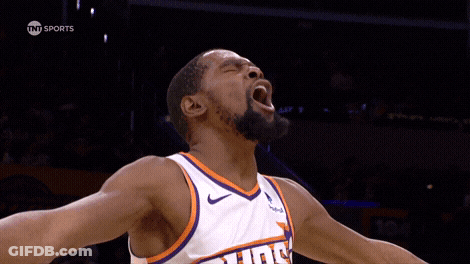 A Basketball Player Wearing A Suns Jersey Is Screaming With His Mouth Open GIF