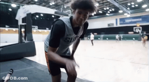 A Basketball Player Wearing A Suns Jersey Stands On A Court GIF