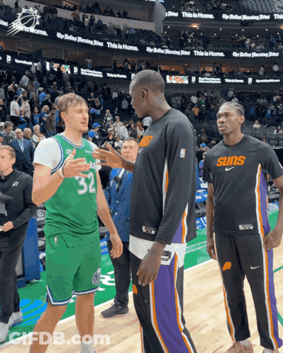A Basketball Player Wearing A Suns Jersey Talks To Another Player GIF