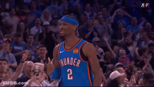A Basketball Player Wearing A Thunder Jersey Is Standing In Front Of A Crowd Of People . GIF