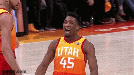 A Basketball Player Wearing A Utah Jersey Is Laughing On The Court GIF