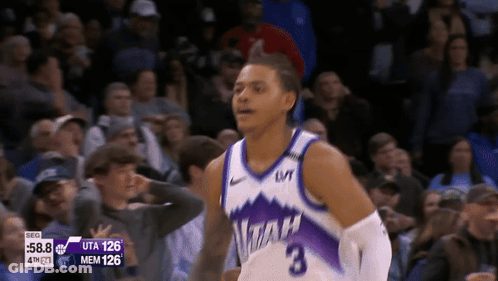 A Basketball Player Wearing A Utah Jersey Stands In Front Of A Crowd GIF