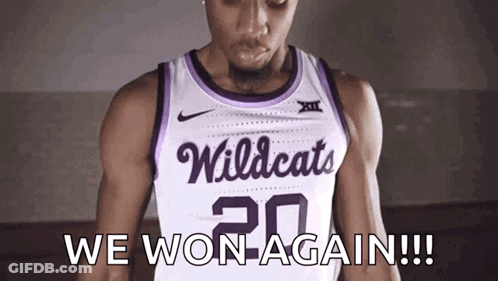 A Basketball Player Wearing A White And Purple Wildcats Jersey GIF