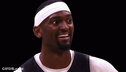 A Basketball Player Wearing A White Headband Smiles GIF