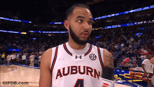 A Basketball Player Wearing A White Jersey That Says Auburn 4 GIF