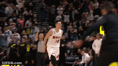 A Basketball Player Wearing A White Jersey With Miami On It GIF