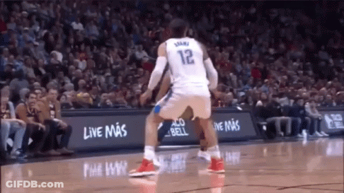 A Basketball Player Wearing A White Jersey With The Number 12 On It GIF