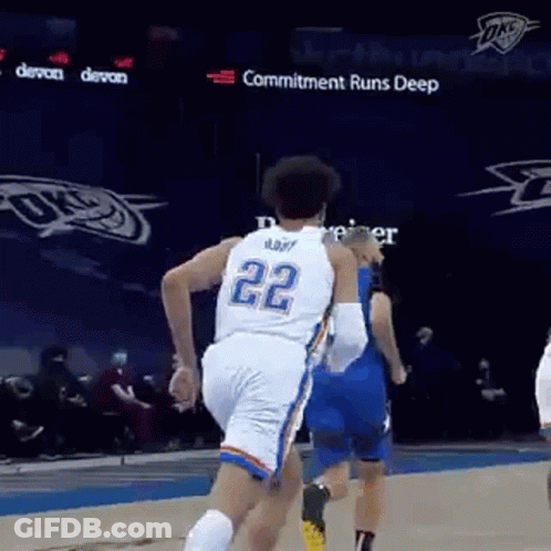 A Basketball Player Wearing A White Jersey With The Number 22 On It Is Running On The Court . GIF