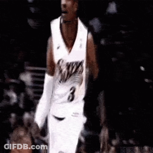 A Basketball Player Wearing A White Jersey With The Number 3 On It . GIF
