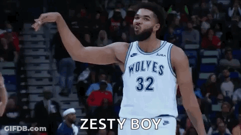 A Basketball Player Wearing A White Jersey With The Number 32 On It Is Standing On A Court . GIF