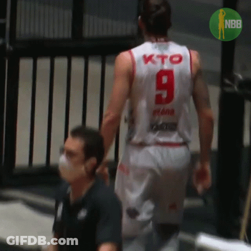 A Basketball Player Wearing A White Jersey With The Number 9 On The Back GIF