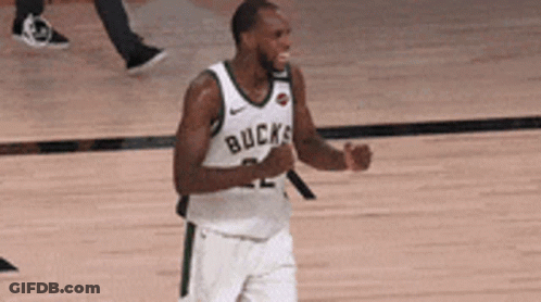A Basketball Player Wearing A White Jersey With The Word Bucks On It Is Standing On A Court . GIF