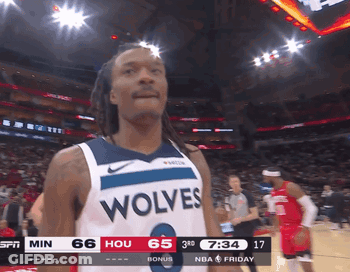 A Basketball Player Wearing A Wolves Jersey Looks At The Camera GIF