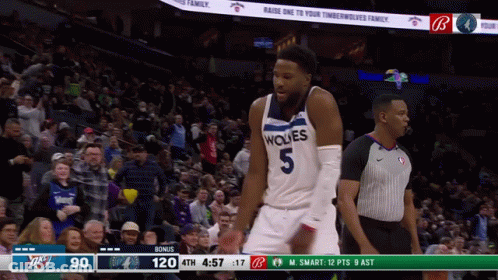 A Basketball Player Wearing A Wolves Jersey Stands In Front Of A Crowd GIF