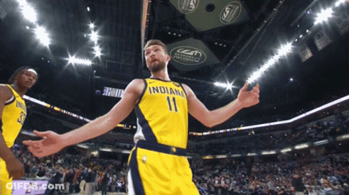 A Basketball Player Wearing A Yellow Indiana Jersey GIF