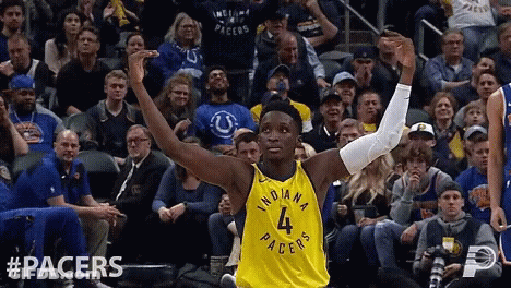 A Basketball Player Wearing A Yellow Indiana Pacers Jersey GIF