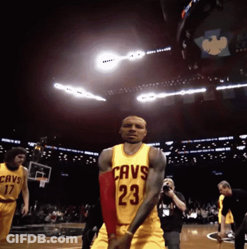 A Basketball Player Wearing A Yellow Jersey With The Number 23 GIF