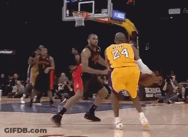 A Basketball Player Wearing A Yellow Jersey With The Number 24 On It Is Dribbling The Ball . GIF