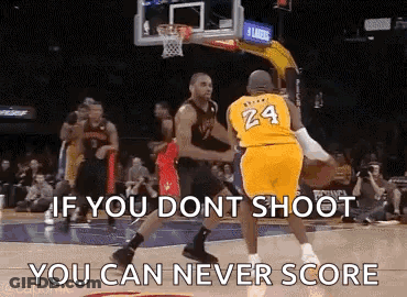 A Basketball Player Wearing A Yellow Jersey With The Number 24 On It Is Trying To Shoot A Basketball At Another Player . GIF