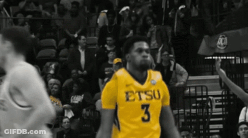 A Basketball Player Wearing A Yellow Jersey With The Number 3 GIF