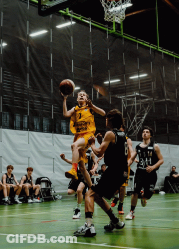 A Basketball Player Wearing A Yellow Jersey With The Number 7 On It Is Jumping In The Air GIF