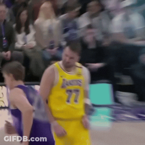A Basketball Player Wearing A Yellow Jersey With The Number 77 GIF
