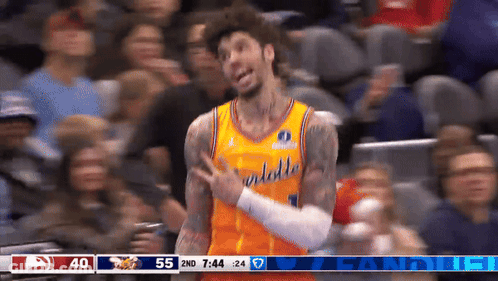 A Basketball Player Wearing A Yellow Jersey With The Word Hawks On It GIF