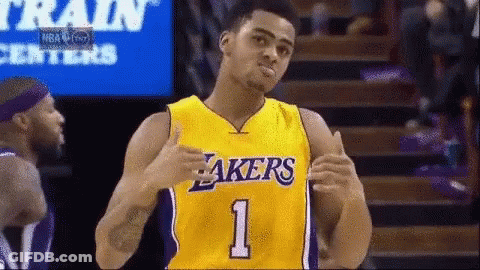 A Basketball Player Wearing A Yellow Lakers Jersey GIF