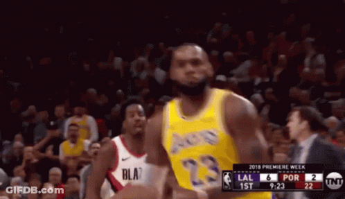 A Basketball Player Wearing A Yellow Lakers Jersey Stands In Front Of A Crowd GIF