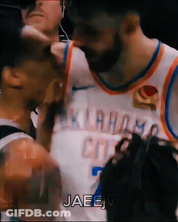 A Basketball Player Wearing An Oklahoma City Jersey Is Talking To Another Player GIF