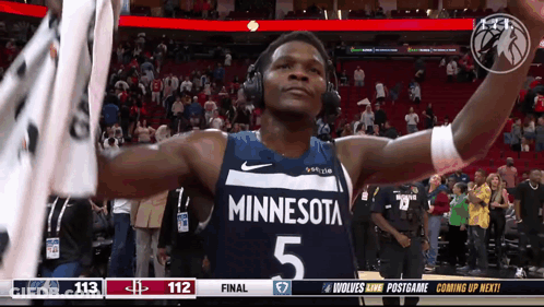 A Basketball Player Wearing Headphones And A Minnesota Uniform GIF