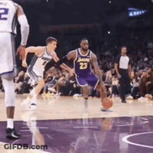 A Basketball Player Wearing Number 23 Is Dribbling The Ball GIF