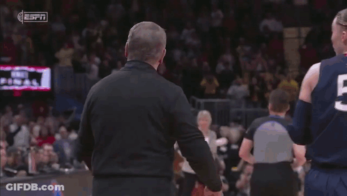 A Basketball Player Wearing Number 24 Is Being Helped By A Man GIF