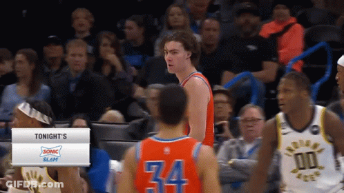A Basketball Player Wearing Number 34 Stands In Front Of Another Player GIF