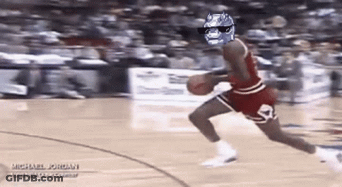 A Basketball Player Wearing Sunglasses And A Batman Mask Is Dribbling A Basketball . GIF